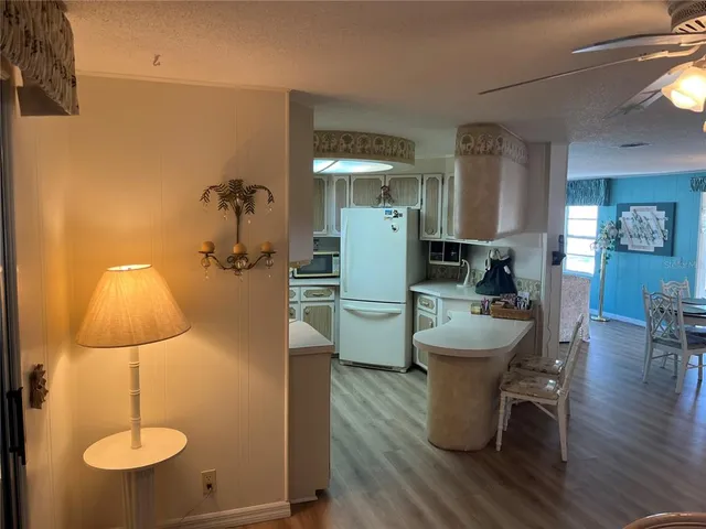 a dining room with furniture and wooden floor