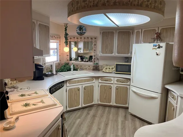 a kitchen with a refrigerator a stove and a sink