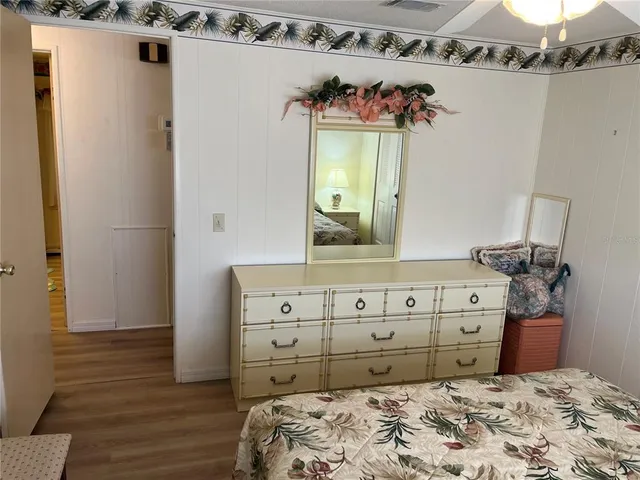 a bedroom with a bed and a dresser