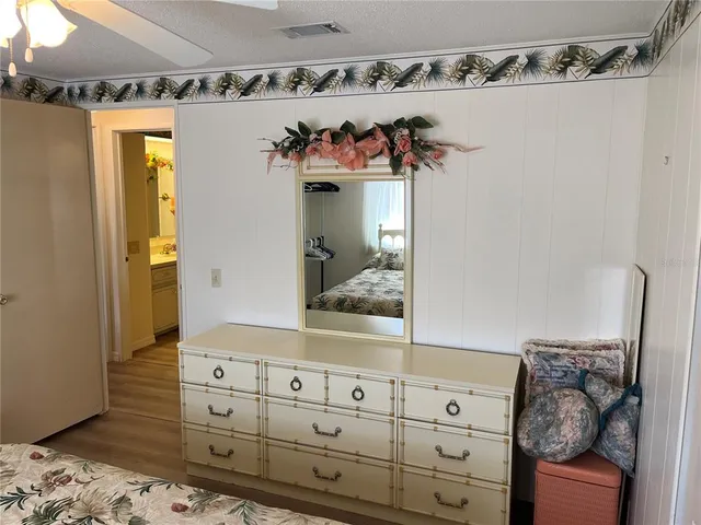 a view of a bedroom with bed and wooden floor