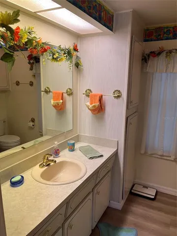 a bathroom with a sink vanity granite and a mirror