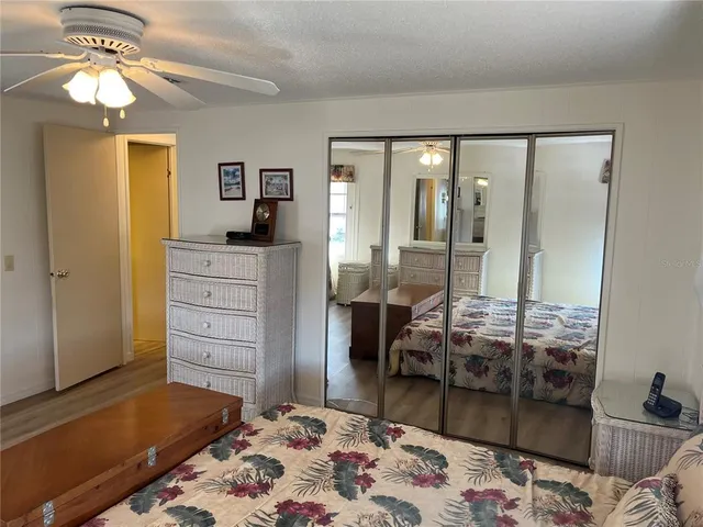 a bedroom with a bed and glass door