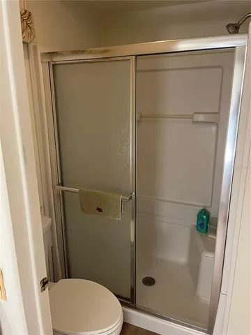 a bathroom with a shower and a toilet