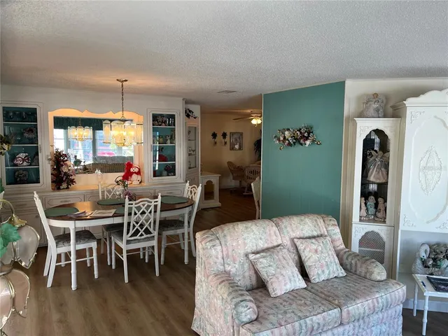 a living room with furniture dining table and a large window