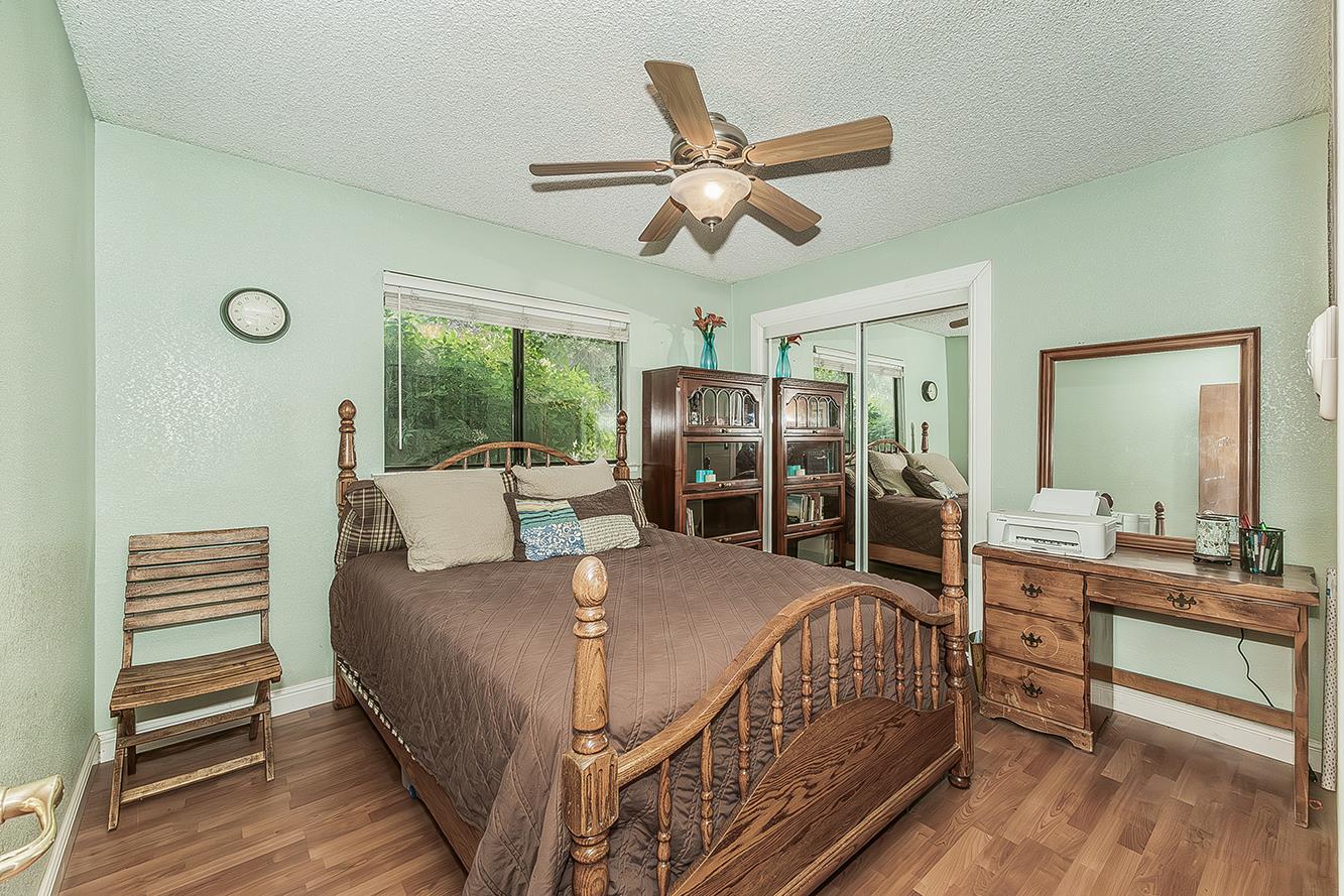 29545 Oak Meadow Road Tollhouse, CA 93667 - Photo 34 of 69 a bedroom with a bed and a chandelier