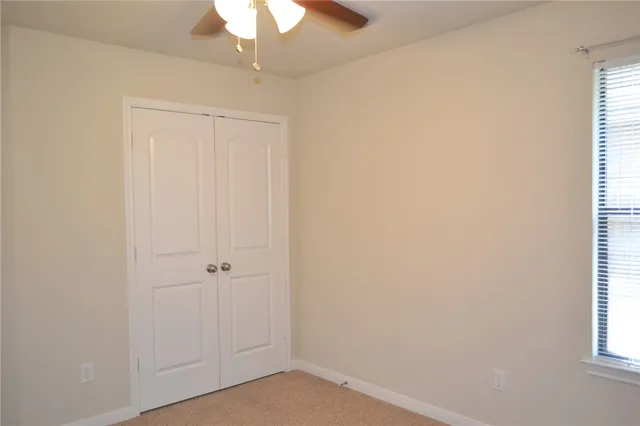 an empty room with windows and entrance