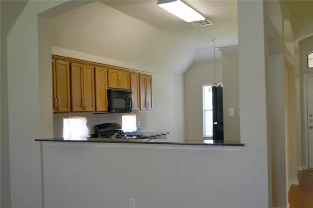 a kitchen with a refrigerator and a window