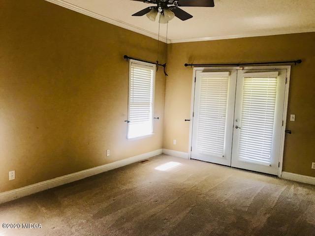 174 Rifle Range Road Gray, GA 31032 - Photo 18 of 39 an empty room with a window and a ceiling fan
