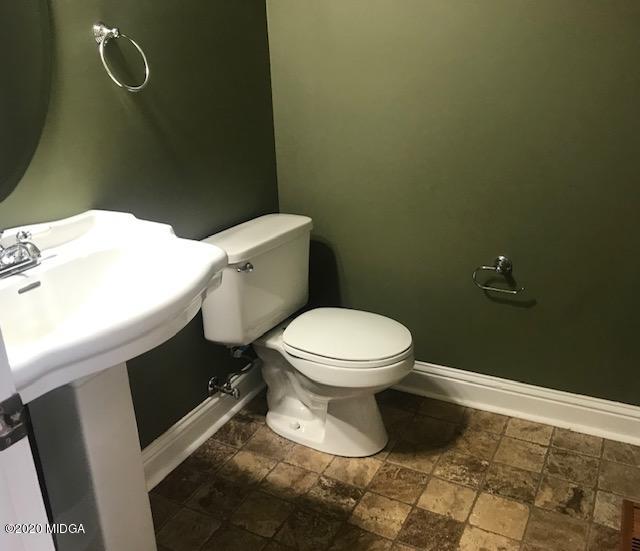 174 Rifle Range Road Gray, GA 31032 - Photo 22 of 39 a white toilet sitting next to a bathroom sink