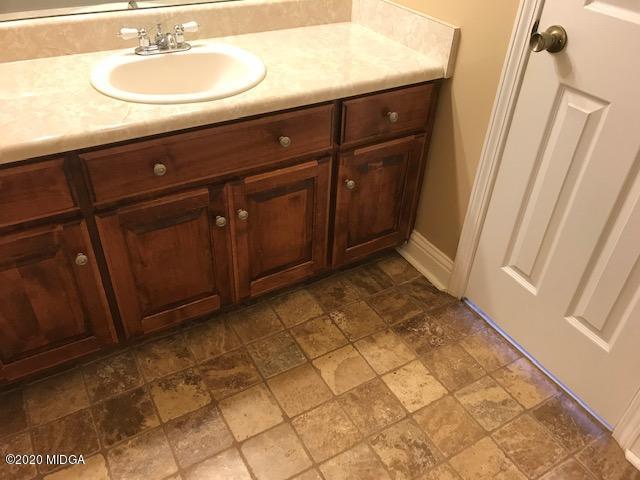 174 Rifle Range Road Gray, GA 31032 - Photo 24 of 39 a bathroom with a sink and a mirror