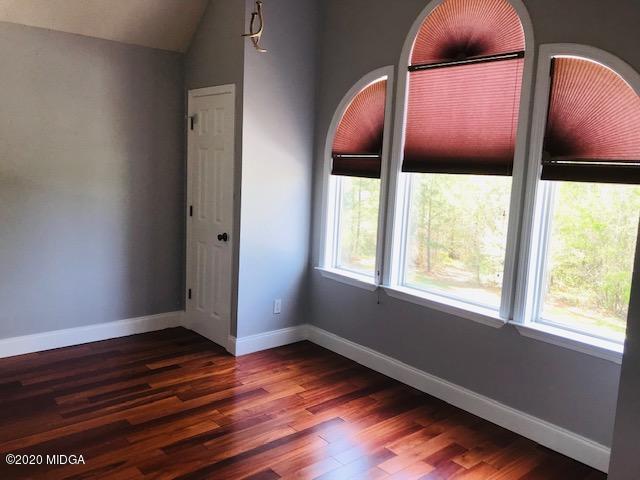 174 Rifle Range Road Gray, GA 31032 - Photo 27 of 39 an empty room with wooden floor and windows