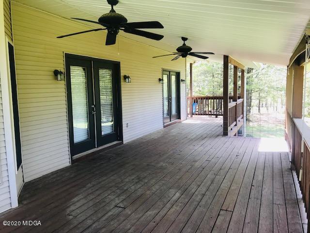 174 Rifle Range Road Gray, GA 31032 - Photo 36 of 39 a view of a porch with wooden floor and fence