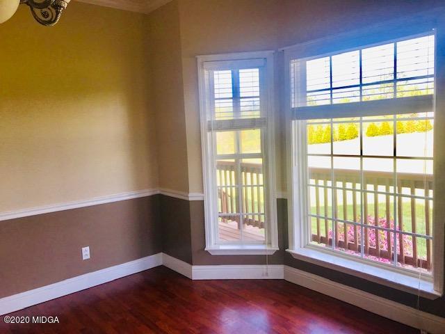 174 Rifle Range Road Gray, GA 31032 - Photo 6 of 39 a view of an empty room with wooden floor and a window