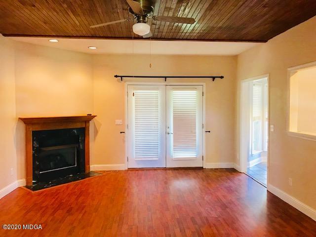 174 Rifle Range Road Gray, GA 31032 - Photo 9 of 39 a view of empty room with wooden floor and fireplace