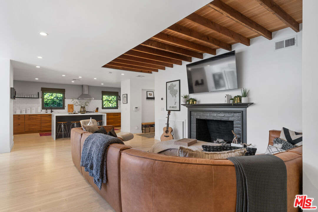 3301 McLaughlin Avenue Los Angeles, CA 90066 - Photo 11 of 46 a living room with furniture a fireplace and a chandelier