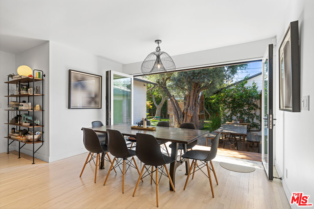 3301 McLaughlin Avenue Los Angeles, CA 90066 - Photo 12 of 46 a dining room with furniture a chandelier and wooden floor