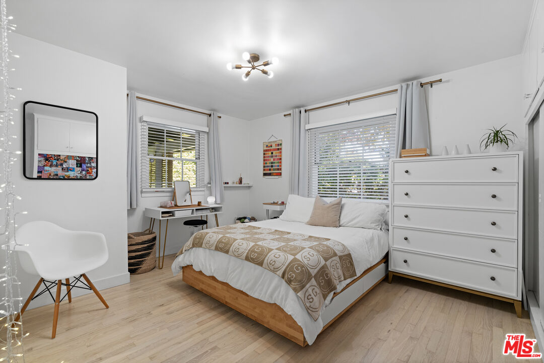 3301 McLaughlin Avenue Los Angeles, CA 90066 - Photo 34 of 46 a bedroom with a bed and a chair with the wooden floor