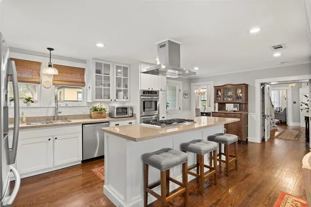 a kitchen with furniture and wooden floor