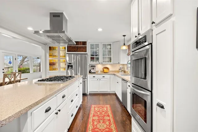 a kitchen with a sink a counter space and cabinets