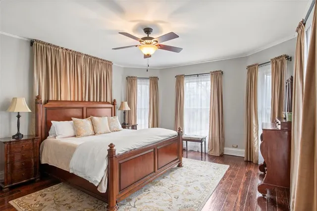 a bedroom with a large bed and a chandelier