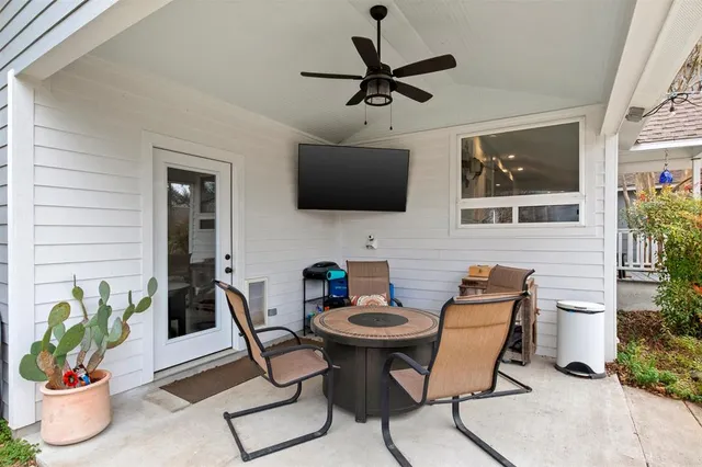 a view of a patio with couches table and chairs and potted plants