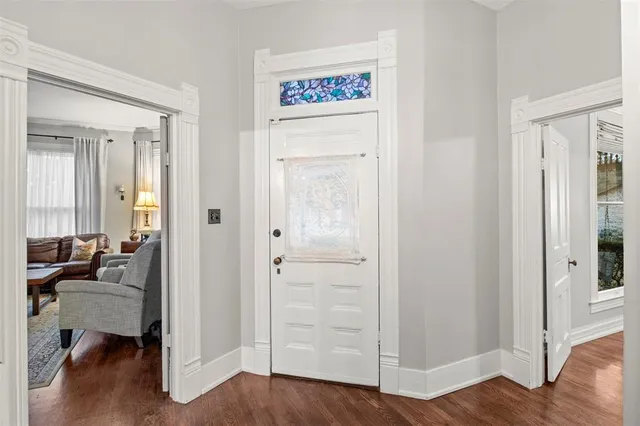 a view of entryway and hall with wooden floor