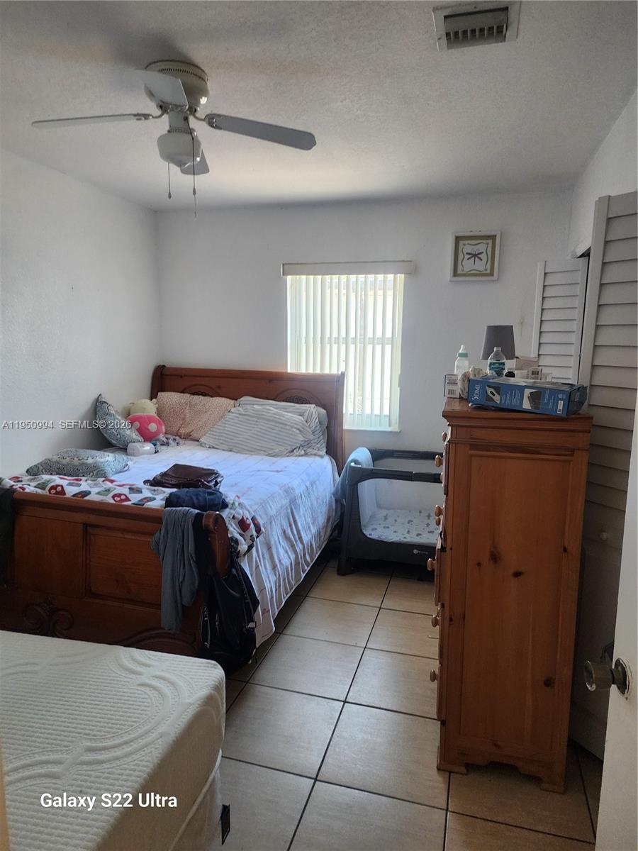 1747 Northwest 85th Street Miami, FL 33147 - Photo 6 of 12 a bedroom with a bed and dresser