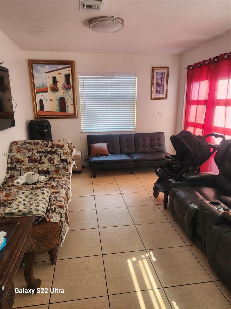 1747 Northwest 85th Street Miami, FL 33147 - Photo 7 of 12 a living room with furniture and a window