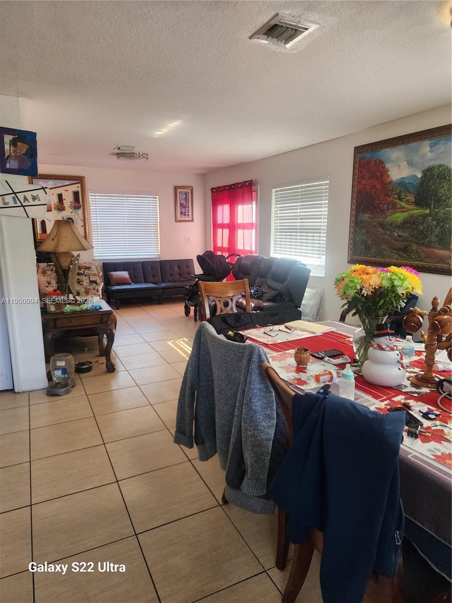 1747 Northwest 85th Street Miami, FL 33147 - Photo 10 of 12 a living room with furniture and a flat screen tv