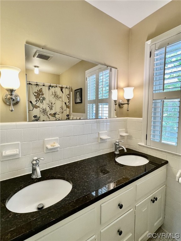 9408 Midvale Road Richmond, VA 23229 - Photo 20 of 24 a bathroom with a granite countertop sink and a mirror