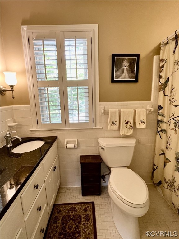 9408 Midvale Road Richmond, VA 23229 - Photo 21 of 24 a bathroom with a granite countertop toilet sink and mirror