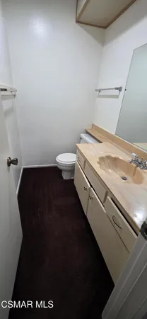 a bathroom with a granite countertop sink