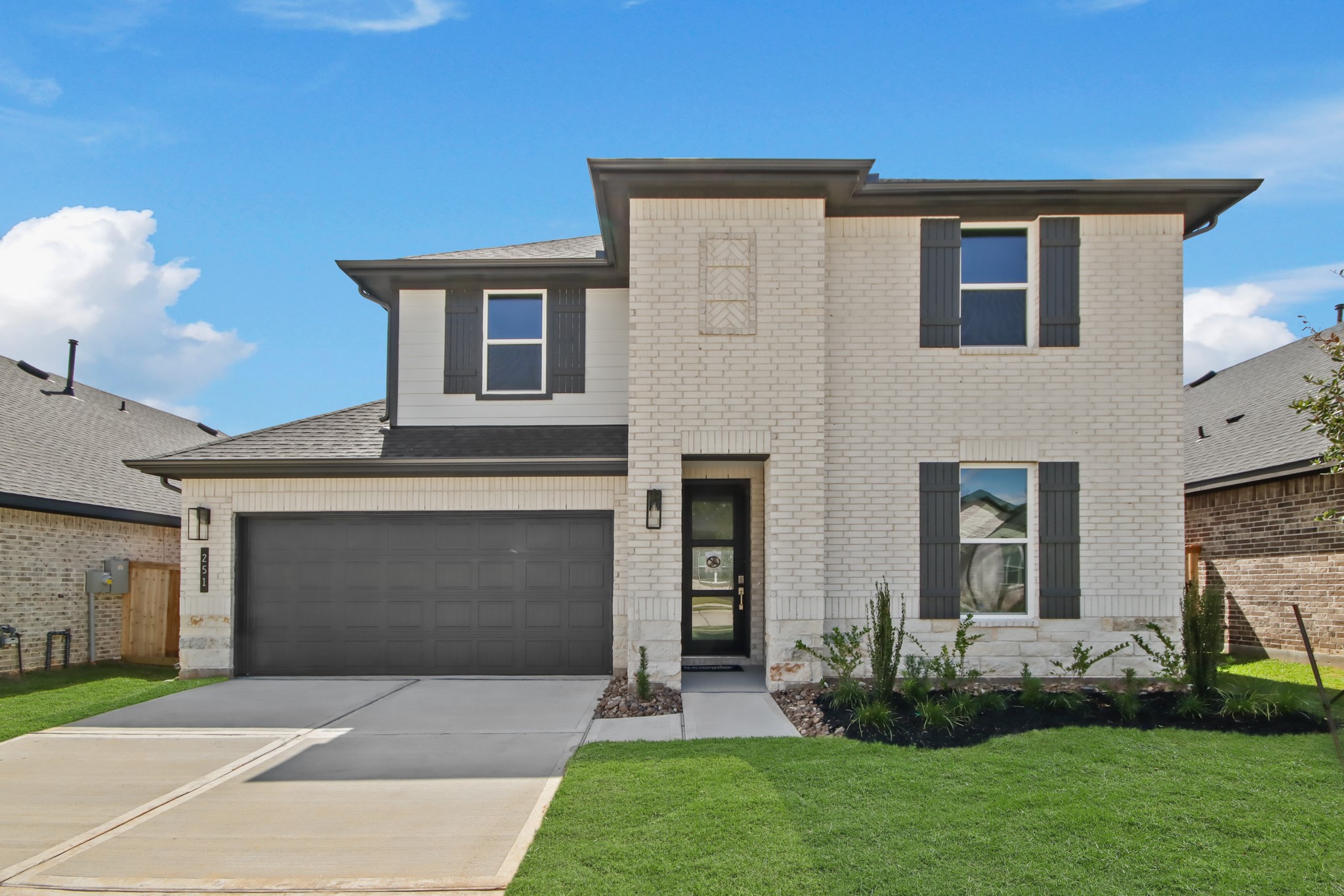 251 Springfield Terrace Drive Conroe, TX 77304 - Photo 2 of 23 a front view of a house with a garden and yard