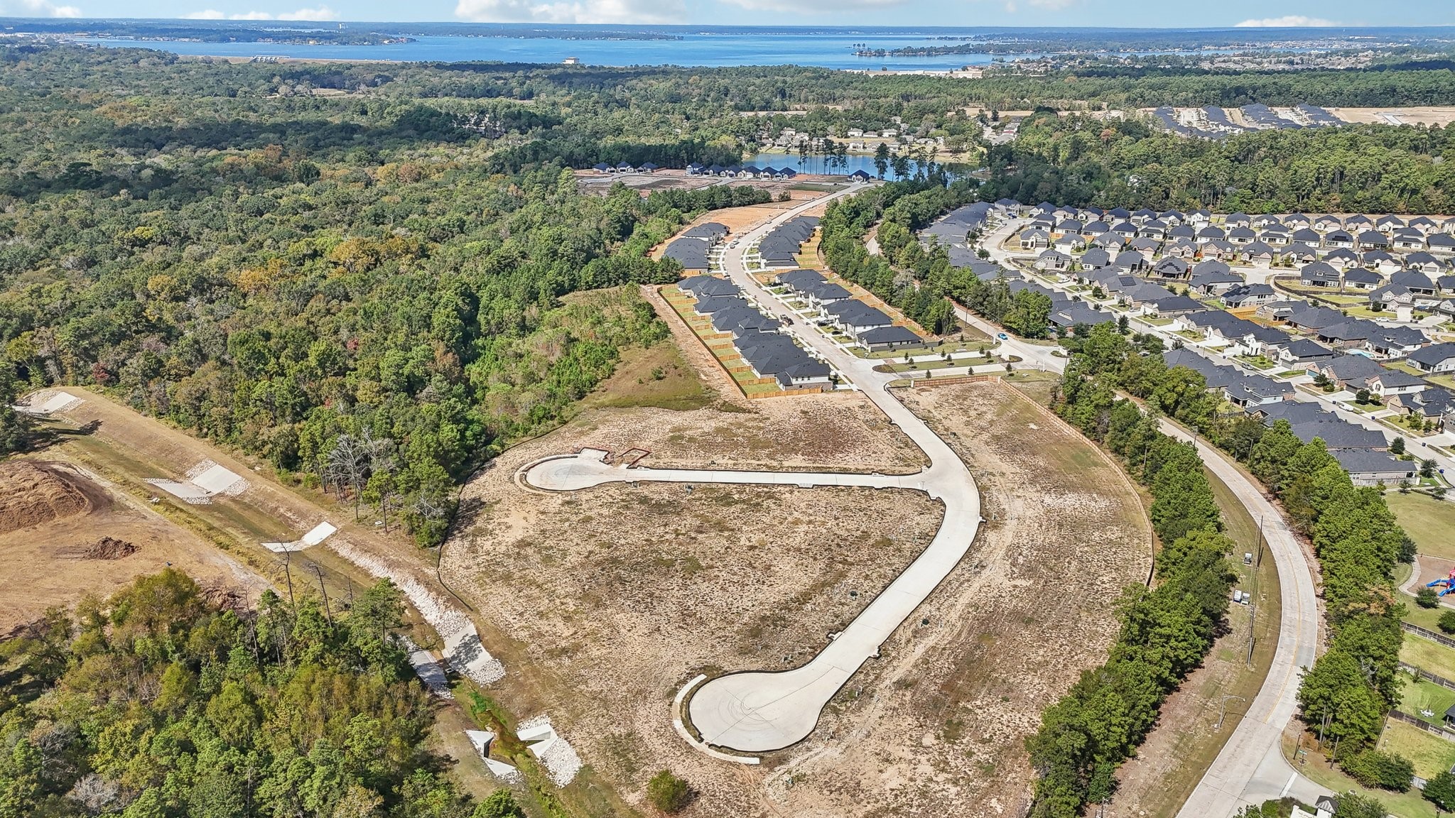 251 Springfield Terrace Drive Conroe, TX 77304 - Photo 21 of 23 an aerial view of a house with a yard and lake view
