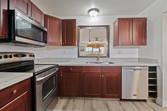 a kitchen with stainless steel appliances granite countertop a sink stove and microwave
