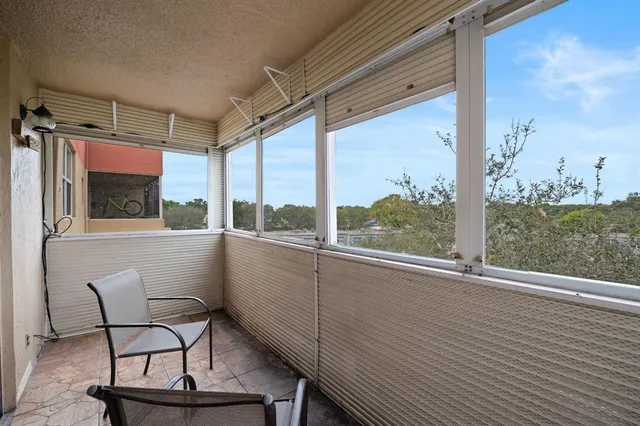 a view of a porch with furniture and yard