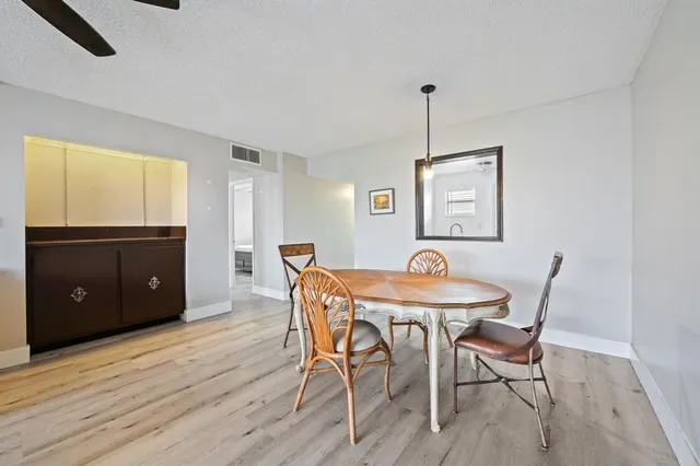a view of a dining room with furniture and window