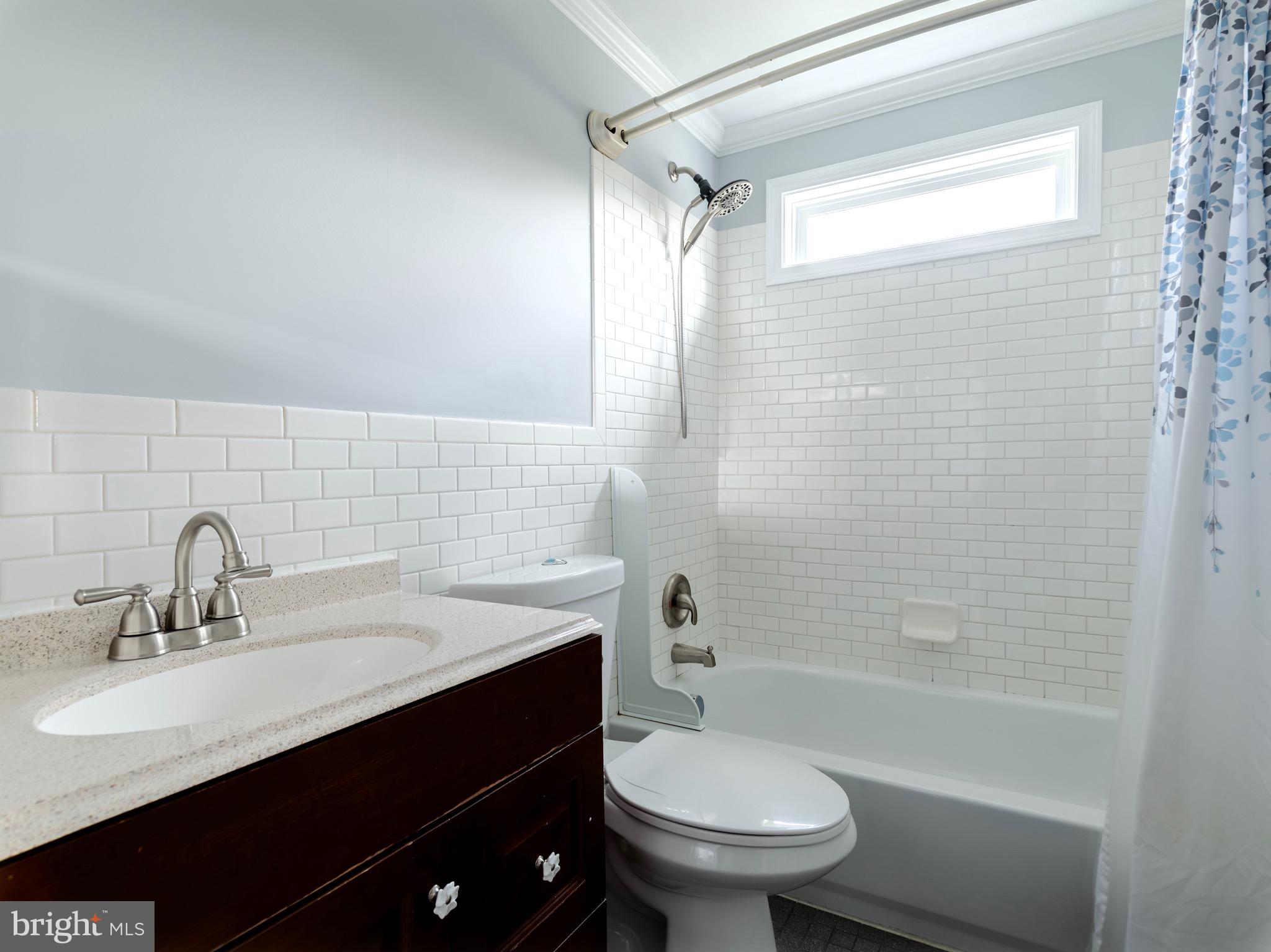 16 Norva Avenue Frederick, MD 21701 - Photo 12 of 15 a bathroom with a sink a toilet and shower