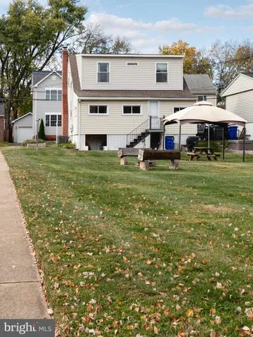 a aerial view of a house with a yard and balcony
