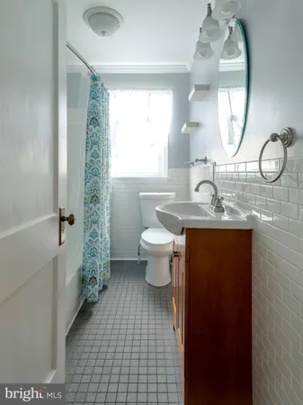 a bathroom with a toilet a sink and a mirror