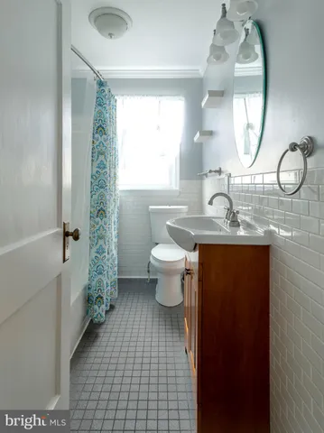 a bathroom with a toilet a sink and a mirror