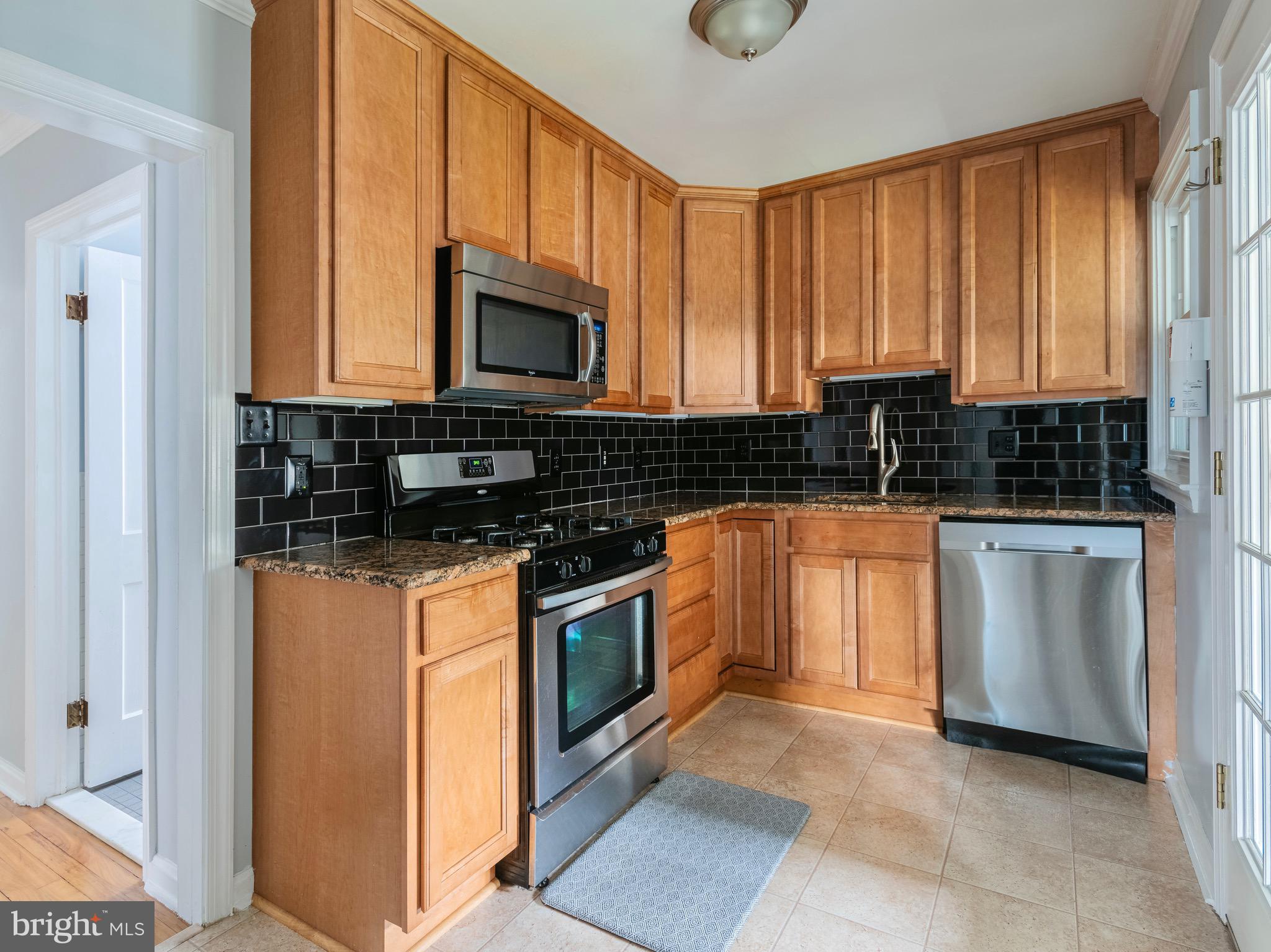 16 Norva Avenue Frederick, MD 21701 - Photo 9 of 15 a kitchen with stainless steel appliances granite countertop a stove a sink and a microwave