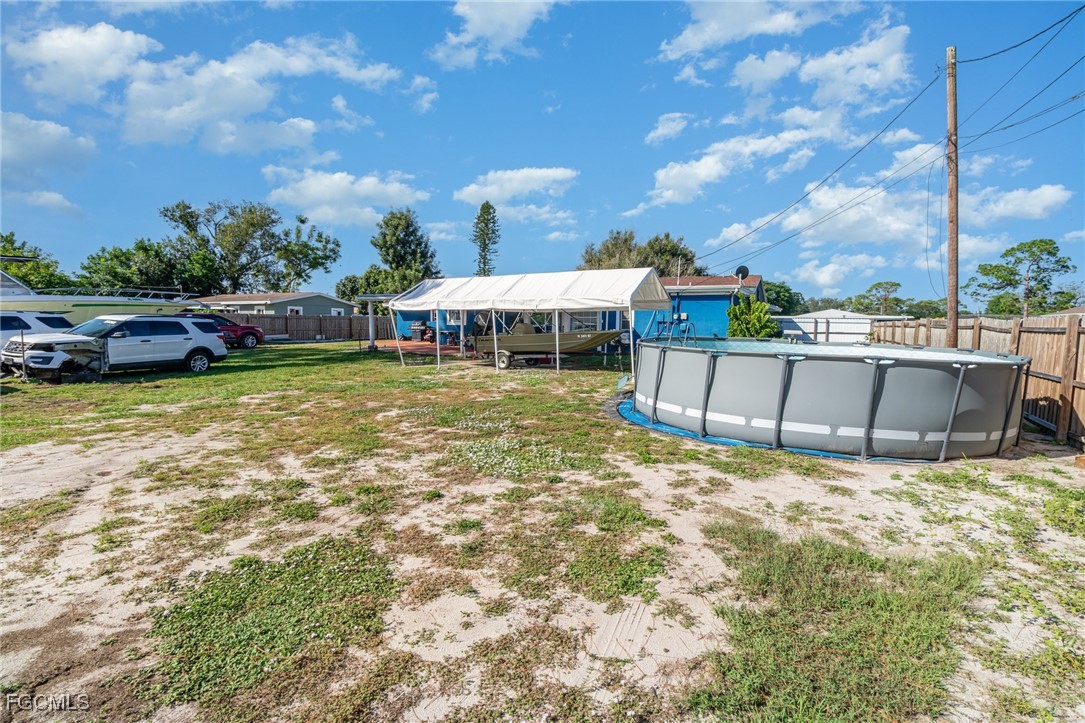 18 Illinois Road Lehigh Acres, FL 33936 - Photo 13 of 28 a view of a swimming pool with a patio and a yard
