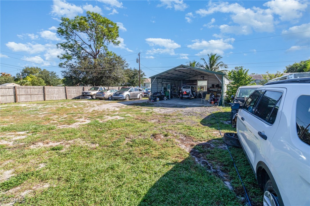 18 Illinois Road Lehigh Acres, FL 33936 - Photo 14 of 28 a view of a swimming pool with a patio and a yard