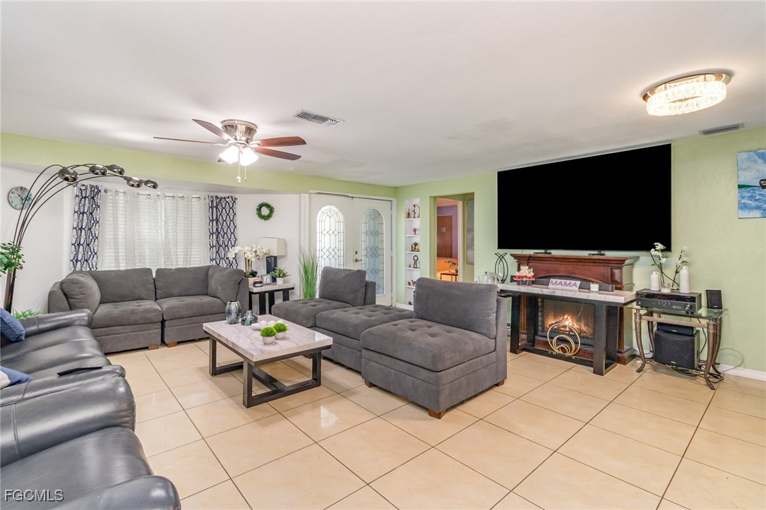 18 Illinois Road Lehigh Acres, FL 33936 - Photo 16 of 28 a living room with furniture and a flat screen tv