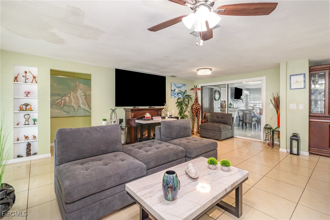 18 Illinois Road Lehigh Acres, FL 33936 - Photo 17 of 28 a living room with furniture and a flat screen tv