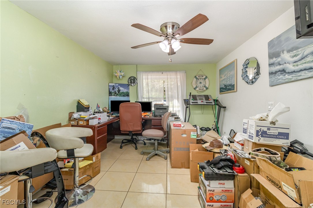 18 Illinois Road Lehigh Acres, FL 33936 - Photo 19 of 28 a room with gym equipment and a view of living room