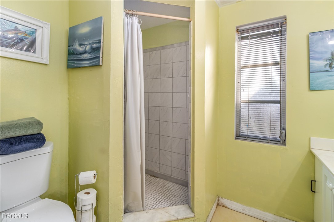 18 Illinois Road Lehigh Acres, FL 33936 - Photo 23 of 28 a bathroom with sink toilet and shower