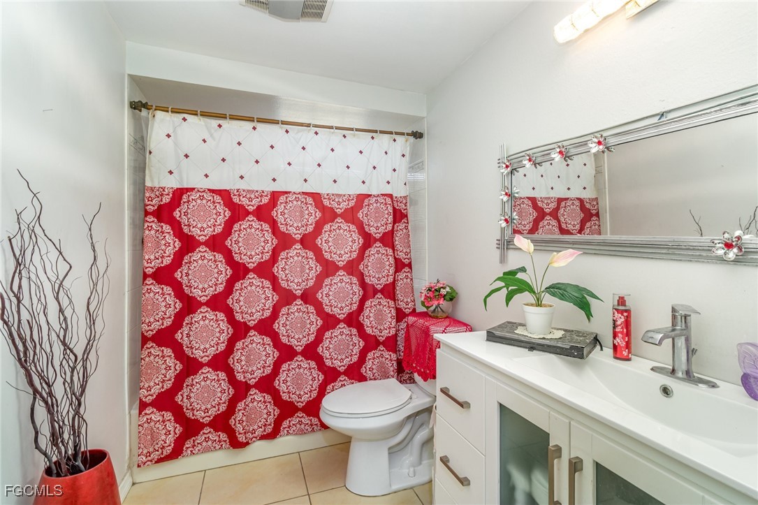 18 Illinois Road Lehigh Acres, FL 33936 - Photo 24 of 28 a bathroom with a sink toilet and mirror