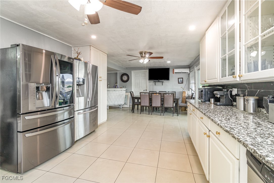 18 Illinois Road Lehigh Acres, FL 33936 - Photo 7 of 28 a kitchen with stainless steel appliances granite countertop a refrigerator and a sink